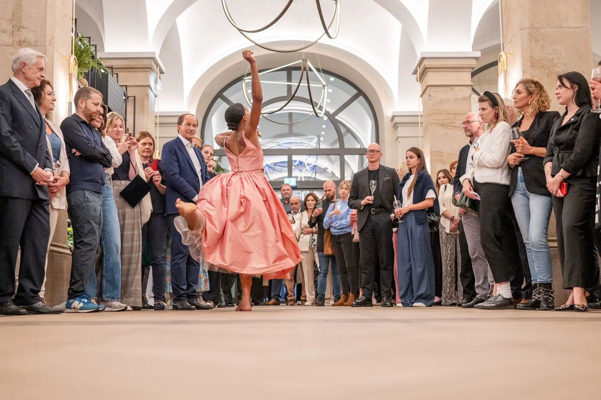 Tänzerin im rosa Kleid performt vor Gästen in der Lobby der Imperial Riding School